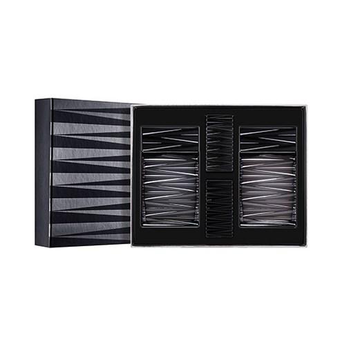 Black and gray patterned gift box with four sleek dark cylindrical skincare containers inside on white background