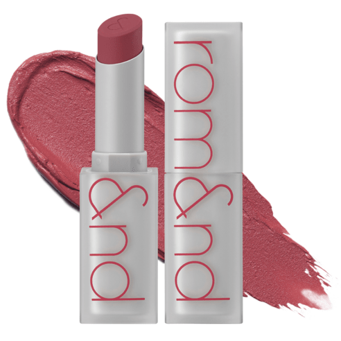 Matte lipstick in dusty pink shade with frosted silver tube and bold red logo, shown with color swatch background.