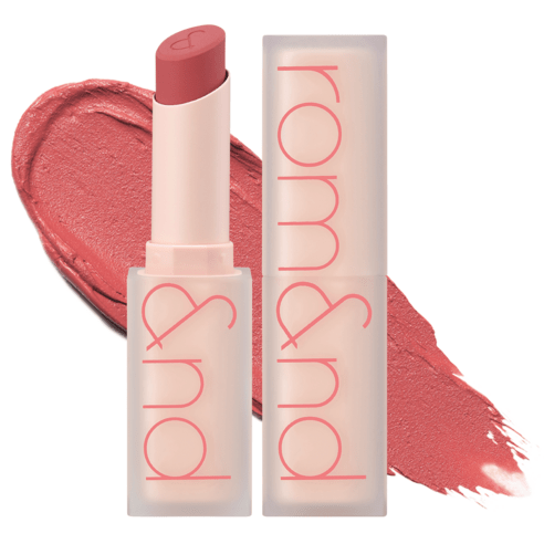 Matte lipstick with creamy texture in muted rose shade displayed with matching color smear background.