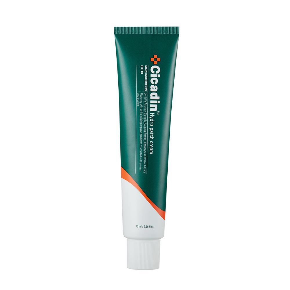 Green and white tube of hydrating patch cream with orange accent for deep skin moisture on white background
