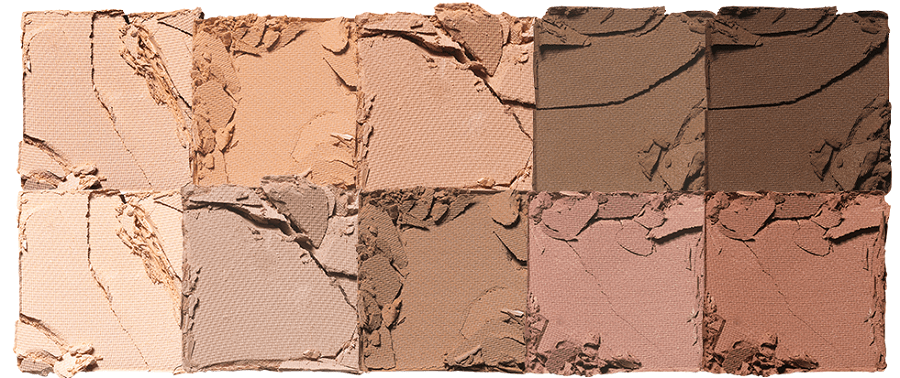 Close-up of neutral and warm earthy tone eyeshadow shades with textured, broken powder surface arranged in rows