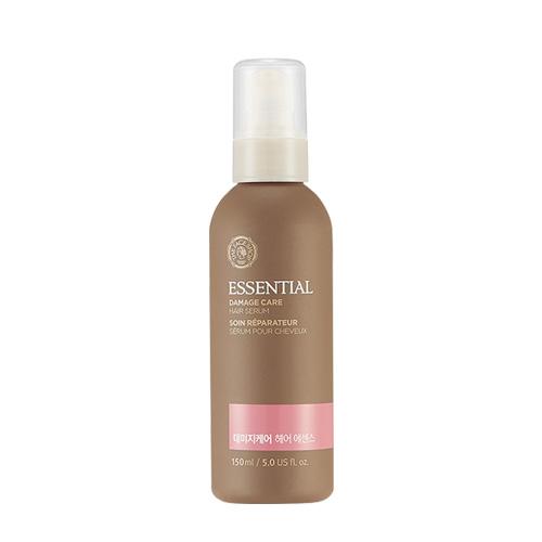 Matte brown bottle of hair oil serum with white pump cap and pink label detail on plain white background