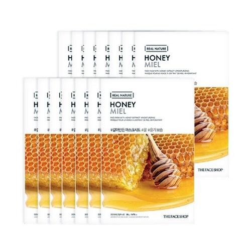 Stack of hydrating honey-infused face masks with honeycomb and wooden dipper on white background