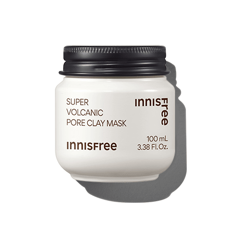 White jar of pore-clearing clay mask with black lid casting shadow on a white background