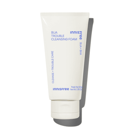 Minimalist white tube of cleansing foam with blue text emphasizing trouble care and oil control benefits on a plain background