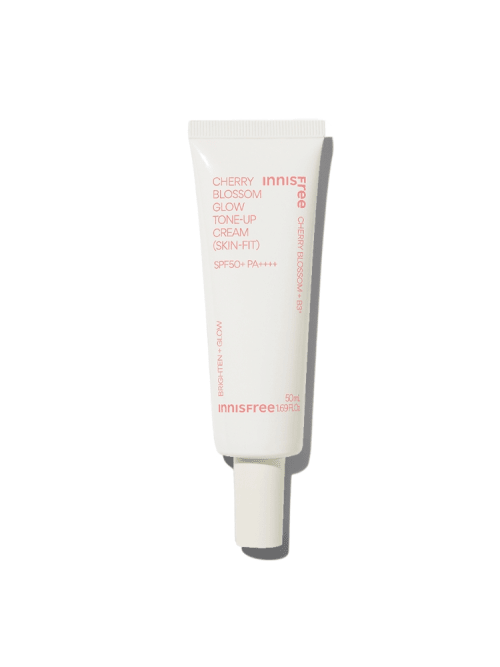 White tube of brightening tone-up cream with pink text and SPF50+ protection on plain white background