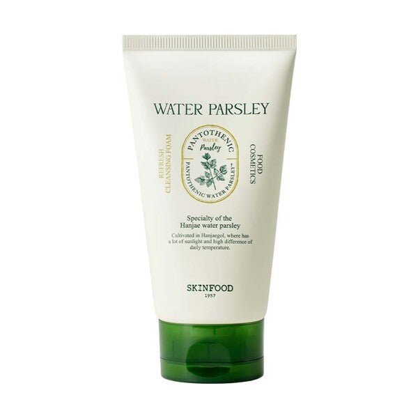 Creamy white cleansing foam tube with green cap and watercolor parsley illustration on clean white background