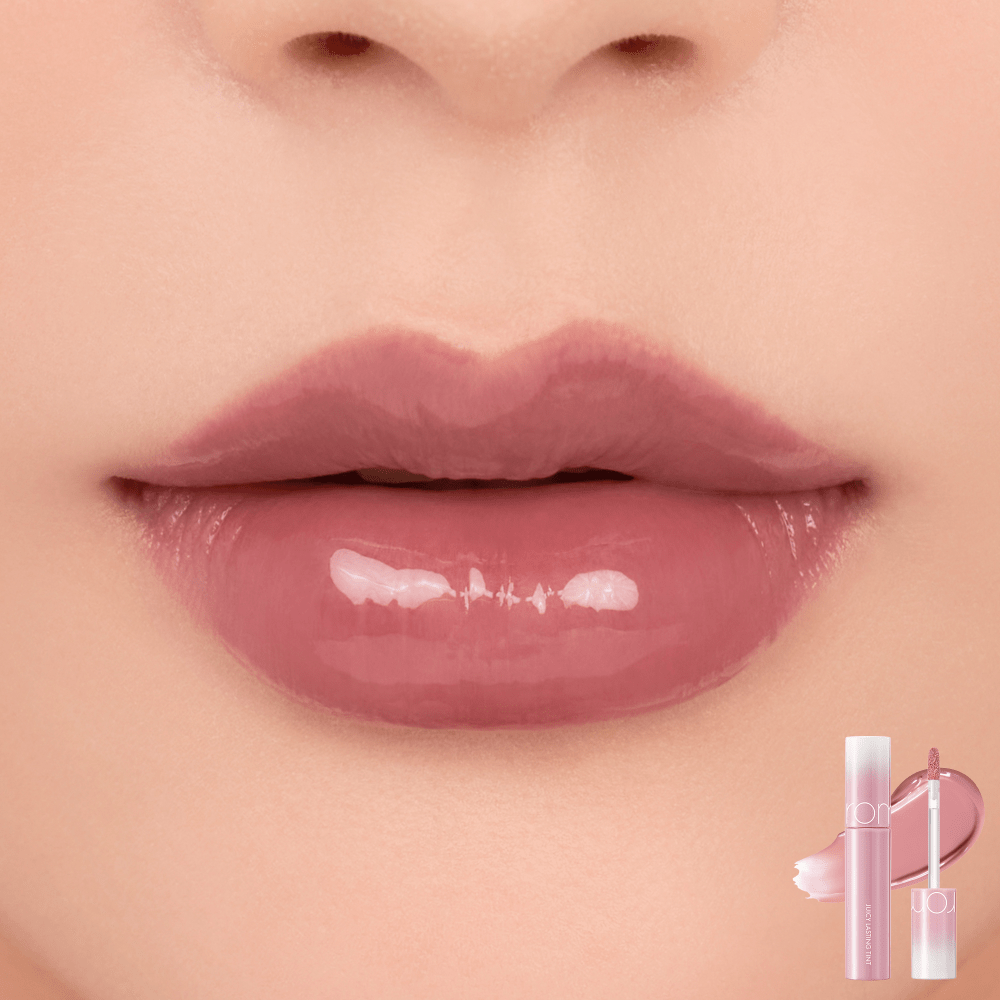 Close-up of lips wearing glossy, natural pink tint with small transparent tube applicator shown in corner.