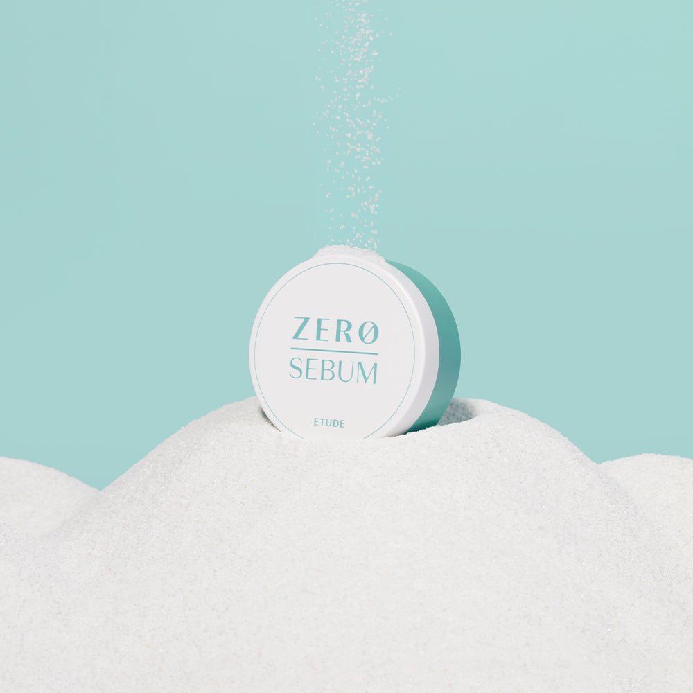 ETUDE Zero Sebum Drying Powder 4g container surrounded by fine white powder representing oil control benefits