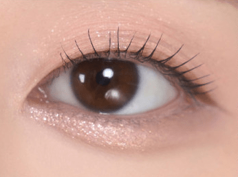 Close-up of an eye showcasing smooth, radiant under-eye skin with subtle shimmer highlighting precision application benefits