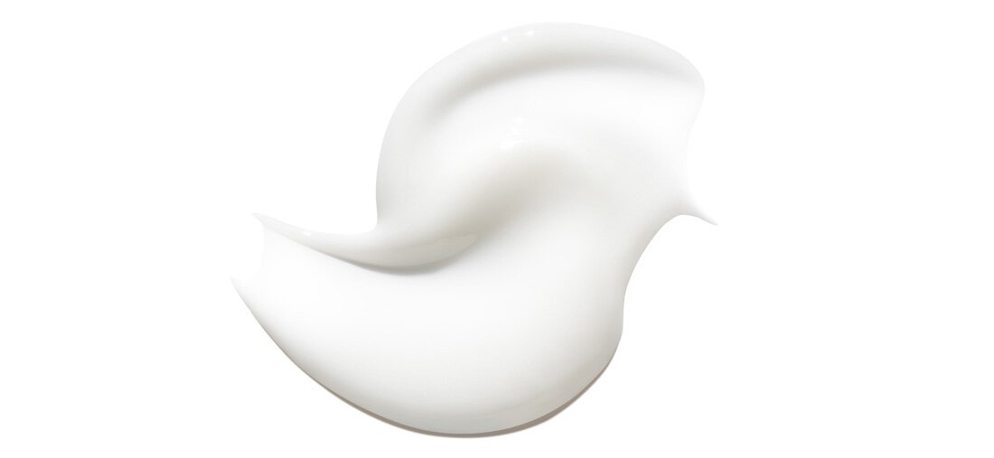 Smooth white serum texture with creamy consistency showcasing radiance-boosting skincare benefits