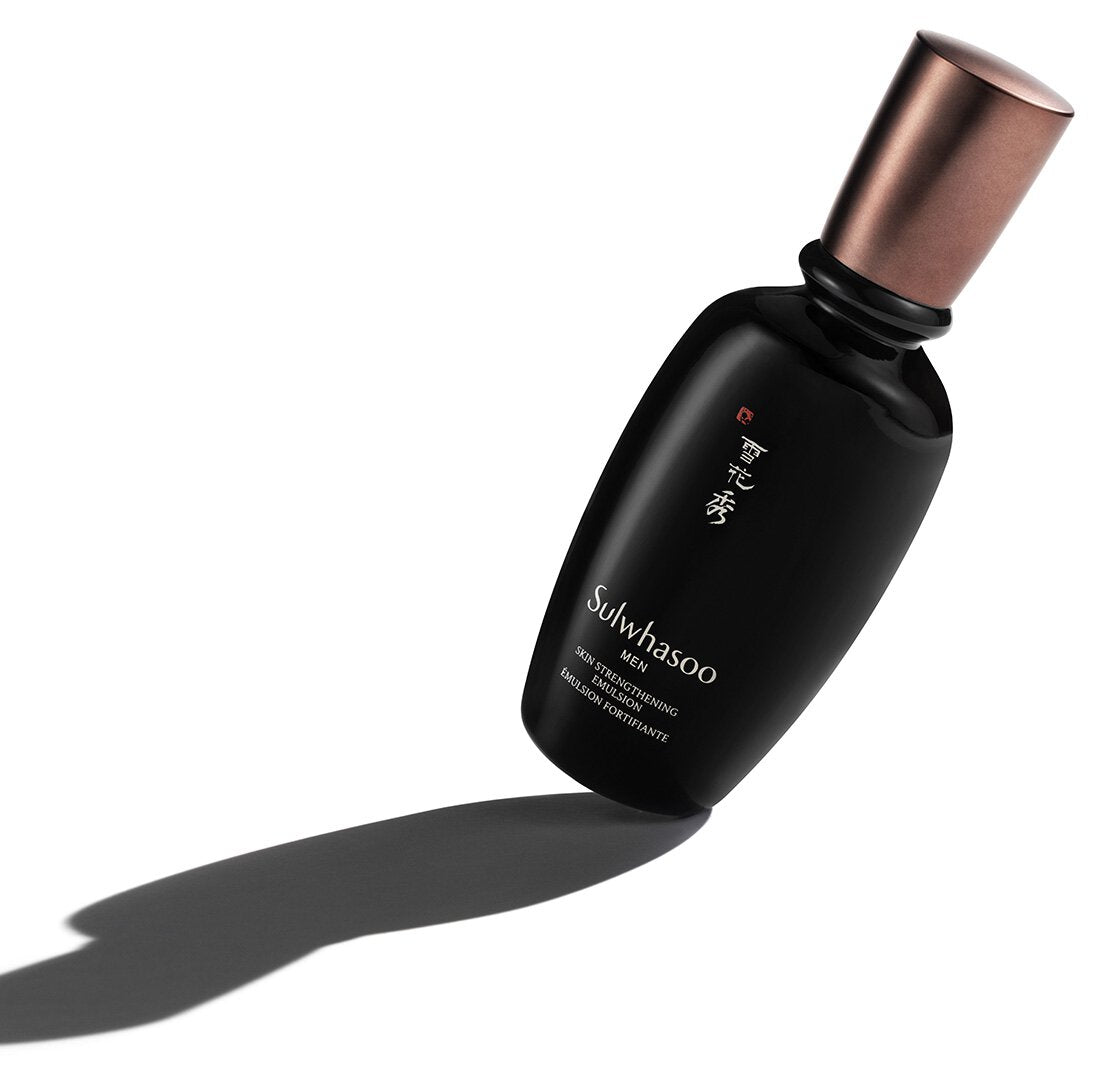 Matte black emulsion bottle with bronze cap casting a long shadow on white background, highlighting hydration benefits