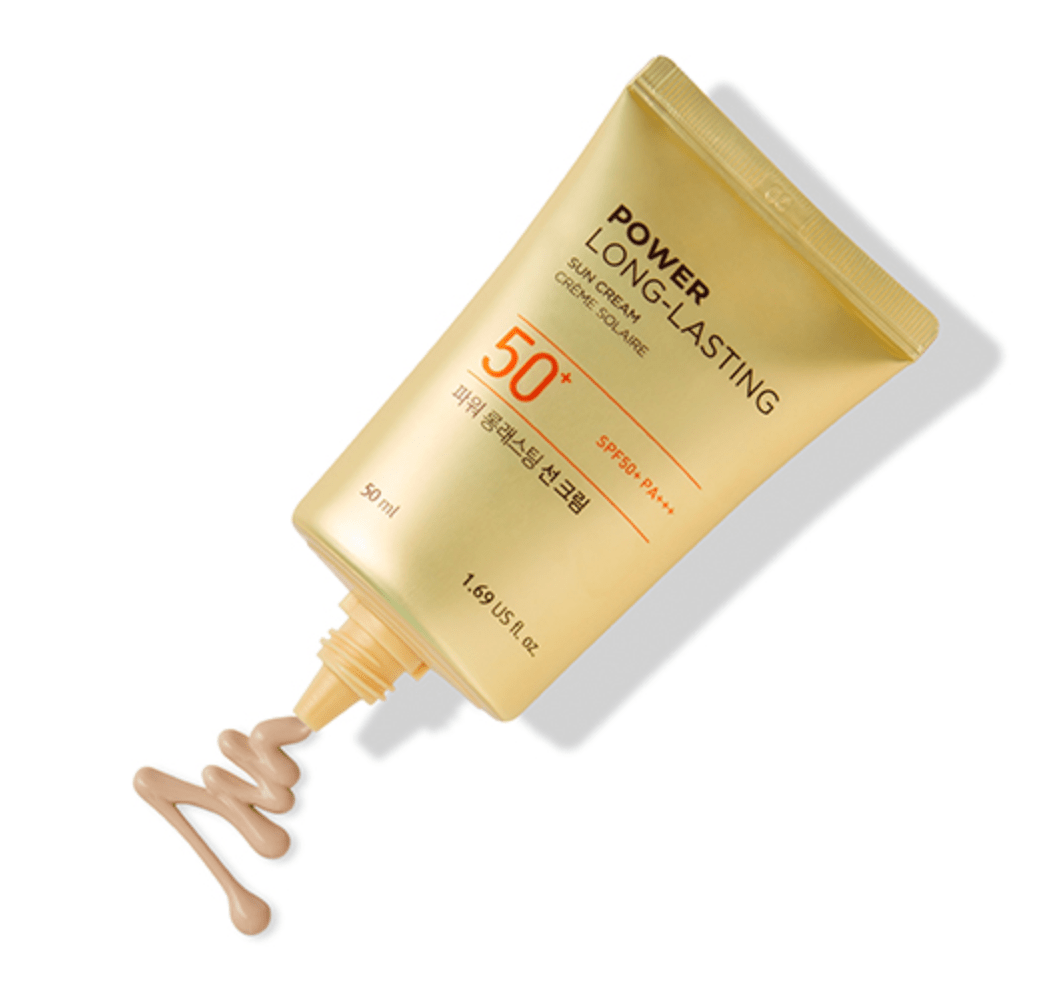 Gold tube of long-lasting sun cream with SPF 50+ broad spectrum protection and beige tinted formula oozing out