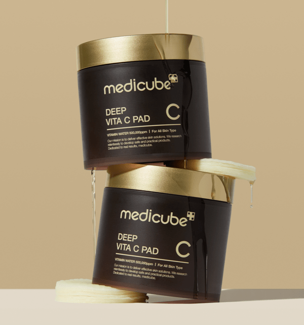 medicube Deep Vita C Pad 150g (70 Pads) jars with liquid dripping, showcasing brightening skincare solution packaging