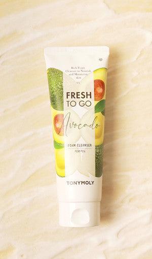 Tube of gentle avocado foam cleanser with fresh fruit illustrations on soft beige marble background