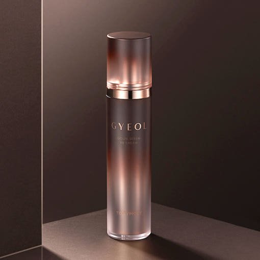 Tall frosted bottle with metallic rose gold cap containing serum BB cream offering a luxurious finish effect