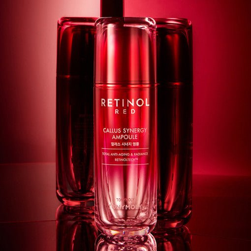 Sleek red serum bottle labeled retinol callus synergy ampoule glowing against reflective red background