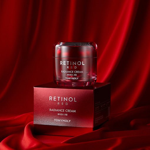 Red tinted jar of radiance cream resting on matching box against rich red satin background for wrinkle care