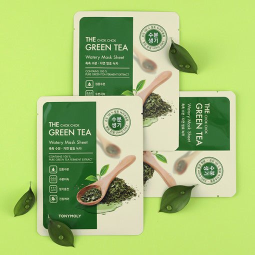 Green tea watery mask sheets with wooden spoon and green leaves on light green background highlighting moisturizing care