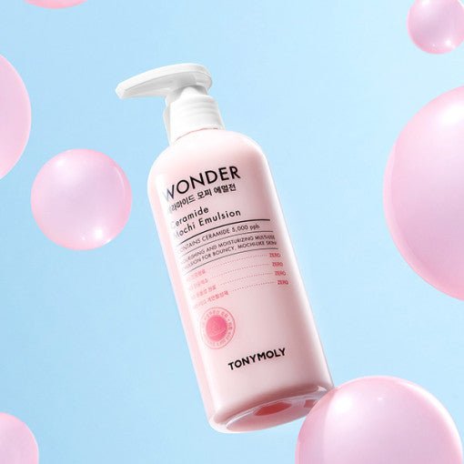 Pink bottle of moisturizing ceramide emulsion with pump surrounded by floating soft pink spheres on blue background
