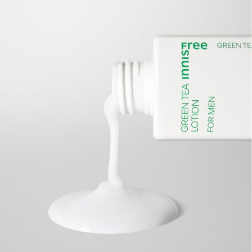 White lotion pouring from a green tea skincare bottle for men, highlighting moisturizing and smooth texture benefits