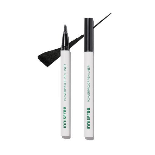 Two white pen liners with green text, one uncapped showing fine black tip and black ink stroke on white background
