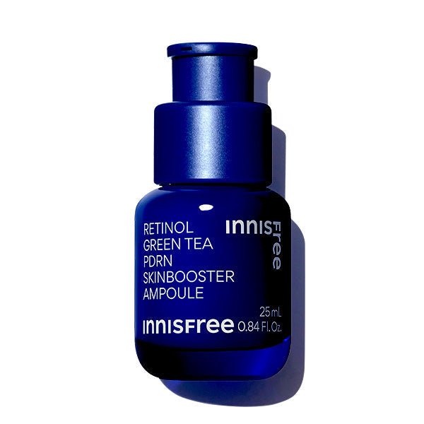 Dark blue glass ampoule bottle with white text highlighting skin texture refinement benefits on white background