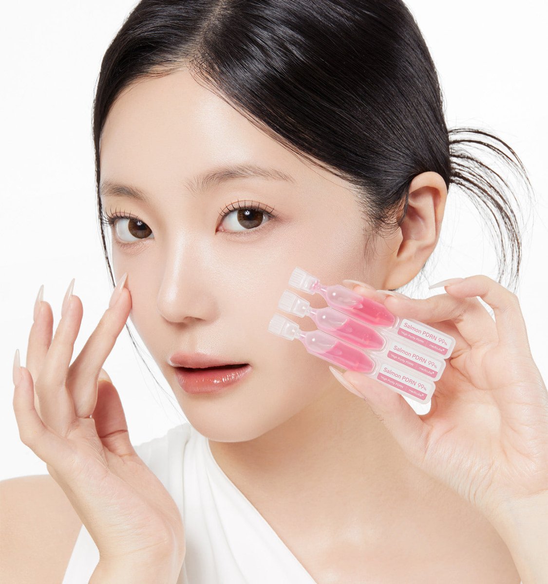medicube PDRN Pink One Day Serum 1box(1.5ml*10ea) held by woman with clear skin for intensive treatment