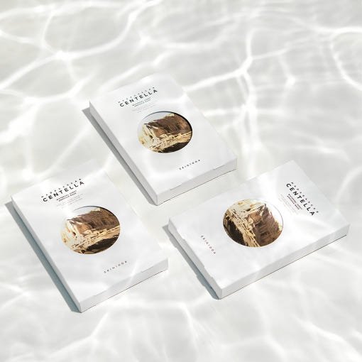 Three white watergel sheet mask packets with natural beige botanical illustration on rippling water surface