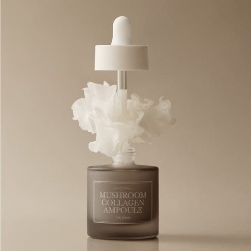 Frosted glass dropper bottle releasing white swirling vapor representing enhanced skin elasticity serum