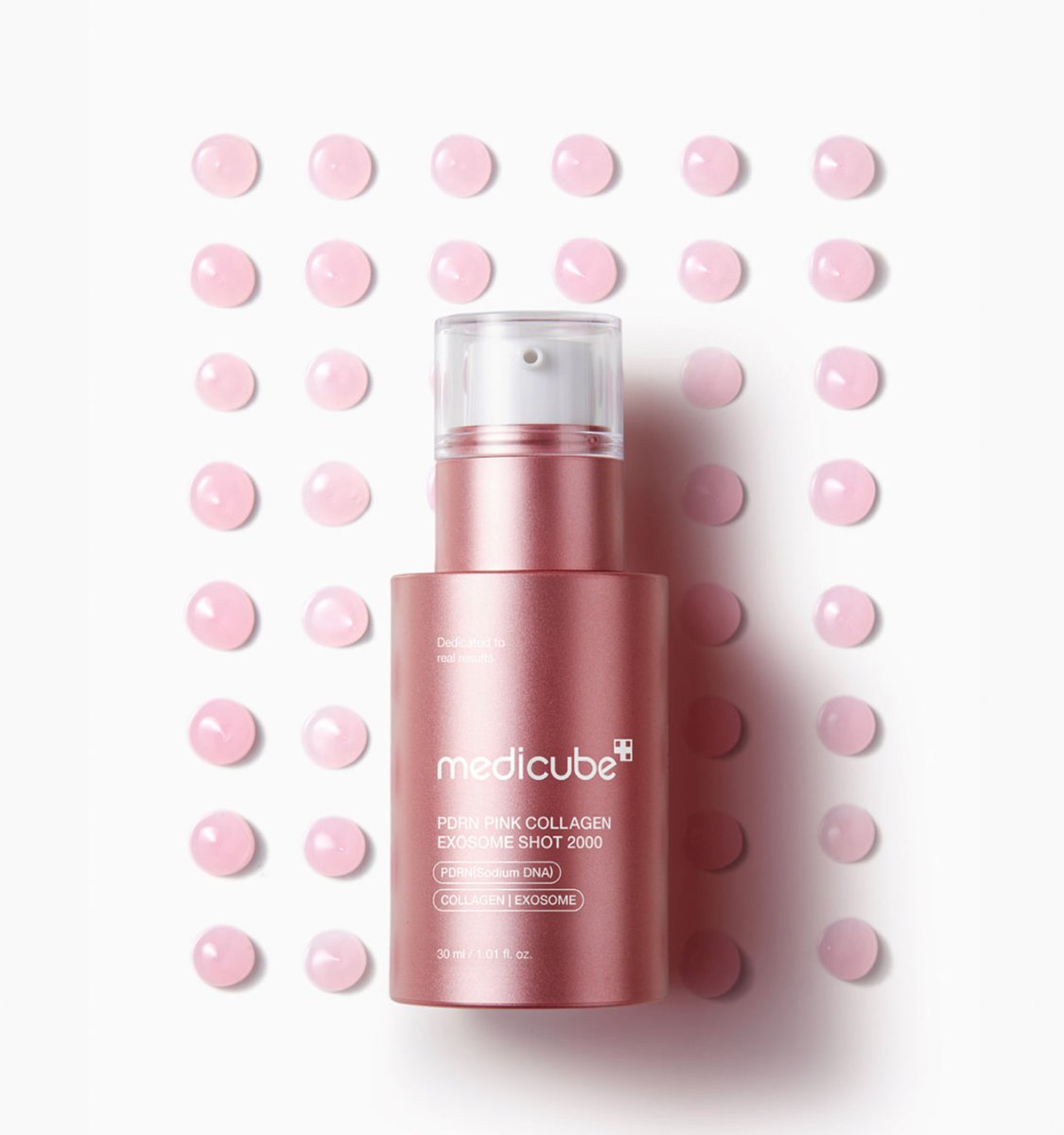 medicube PDRN Pink Collagen Exosome Shot 2000 30ml bottle surrounded by pink serum drops for enhanced radiance