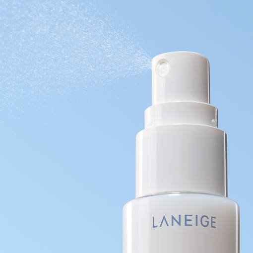 LANEIGE Cream Skin Cerapeptide Mist 30ml in white spray bottle delivering fine moisture boost mist on blue background