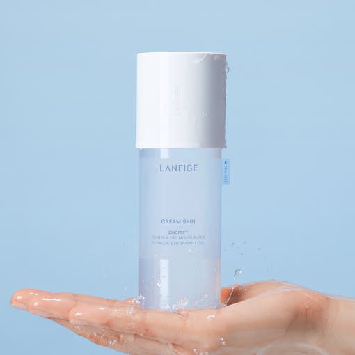 LANEIGE Cream Skin Toner & Gel Moisturizer 170ml held above hand with water droplets highlighting moisture balance benefits