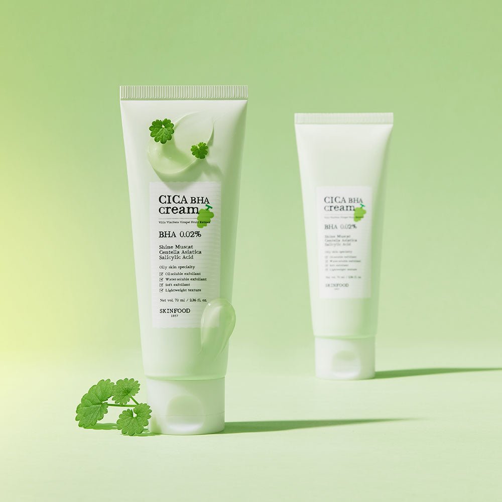 Two pale green tubes of gentle BHA cream with small green leaves on soft green background and smooth cream texture visible