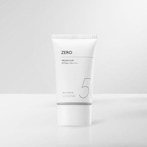 White minimalist tube of vegan sun protection with SPF50+ on plain light gray background providing broad-spectrum care