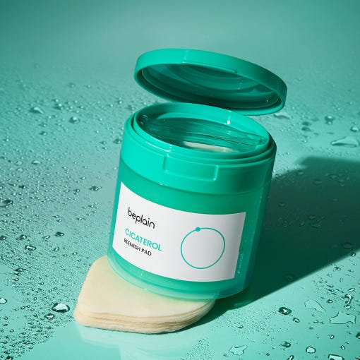 beplain Cicaterol Blemish Pad 80P in teal jar with cooling effect and stacked cotton pads on aqua background