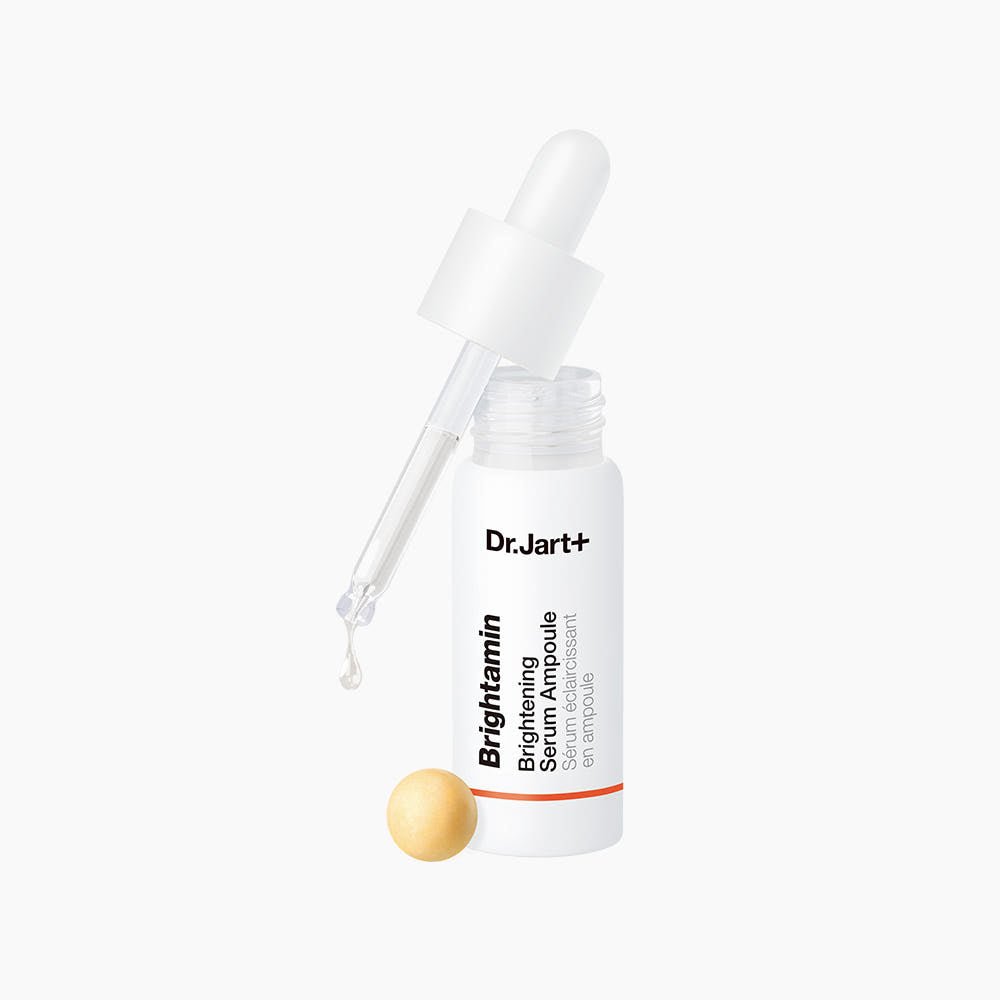 Dr.Jart+ Brightamin Brightening Serum Ampoule 8.08g with dropper dispensing clear liquid on white background