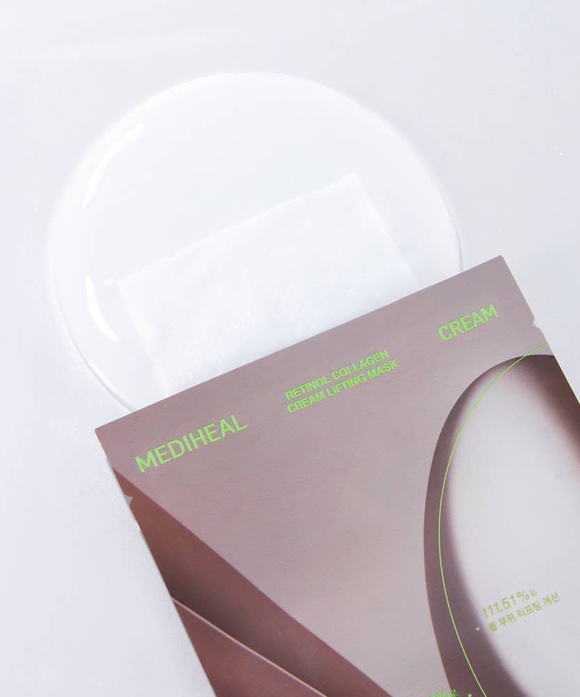 Close-up of a cream lifting mask partially removed from sleek packaging with glossy cream spread underneath.