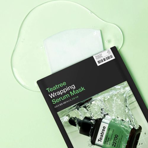 Black packet of serum mask with green text and a clear saturated serum liquid pool with a white sheet mask piece