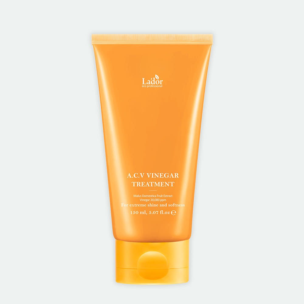 Orange tube of Lador ACV Vinegar Treatment with text highlighting damage repair benefits on plain light background