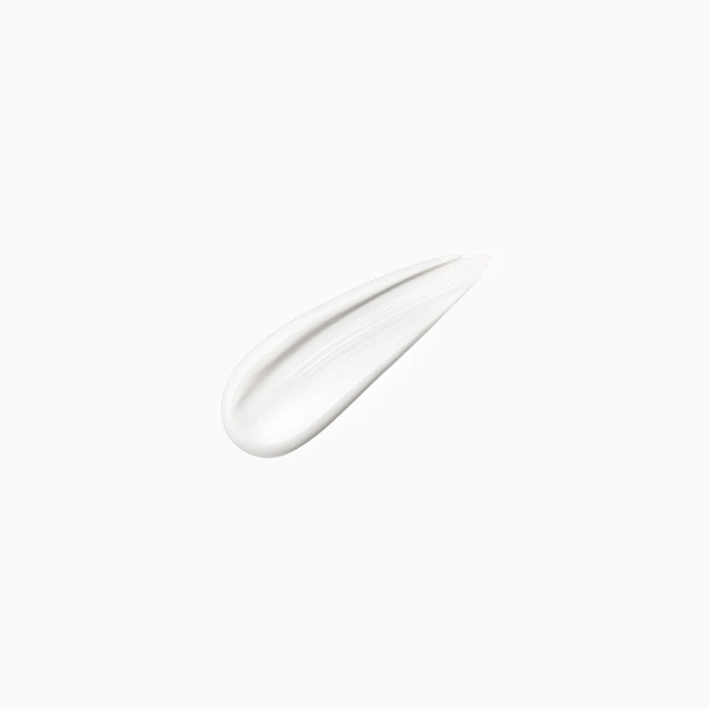 Smooth white hair treatment cream smear showing texture and consistency for strengthening hair benefits