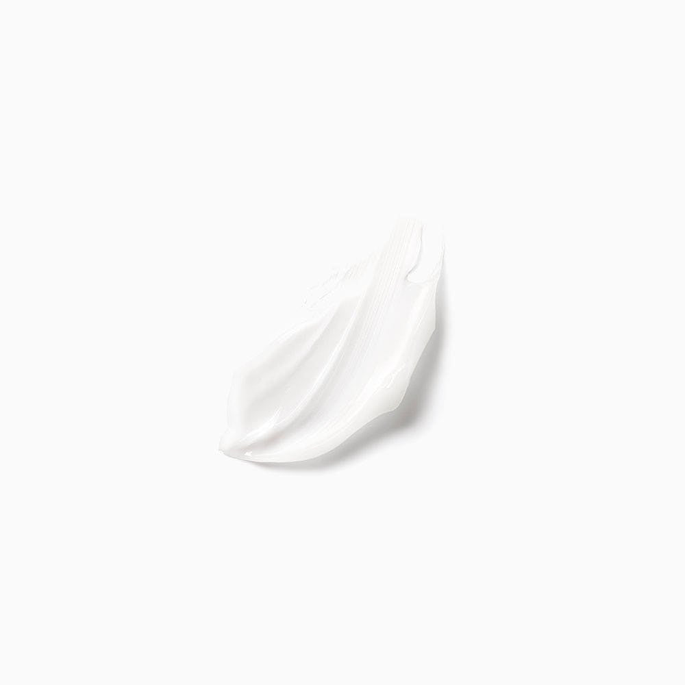 Smooth white creamy texture sample of rejuvenating hair ampoule treatment on white background