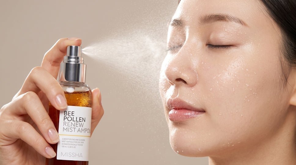 Woman with closed eyes receiving facial mist from a Bee Pollen Renew Mist bottle