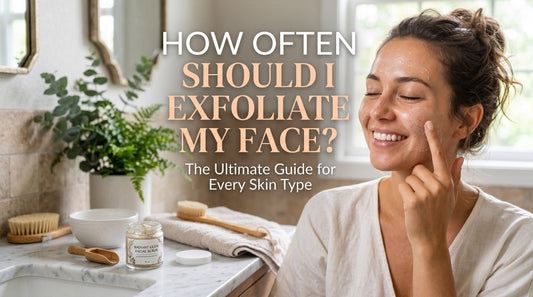 Woman smiling while applying exfoliant cream to her cheek in a bright bathroom with skincare products on the counter