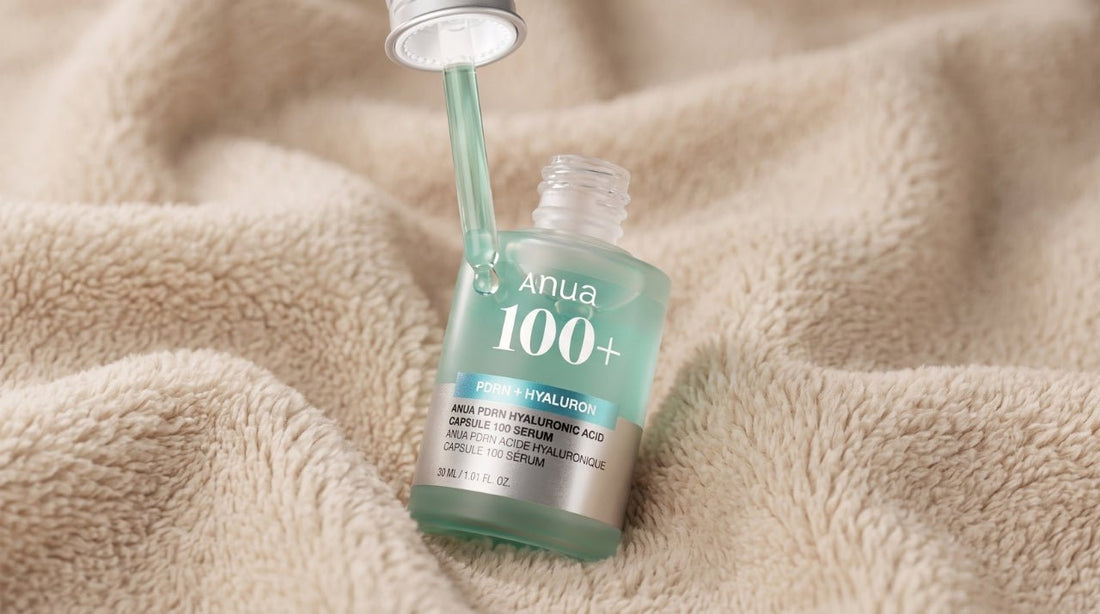 Green Anua PDRN Hyaluronic Acid Capsule 100 Serum bottle with a dropper cap resting on a soft beige fleece blanket