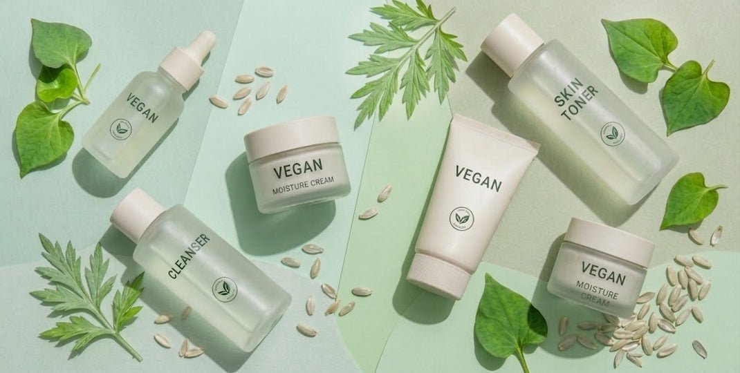 Vegan skincare bottles and jars with cleanser toner and botanical leaves on a pale green background