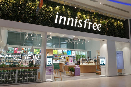 Innisfree store entrance with green wall, showcasing natural beauty products from Jeju.