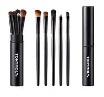 Set of five sleek black makeup brushes with soft bristles displayed beside matching closed tube container