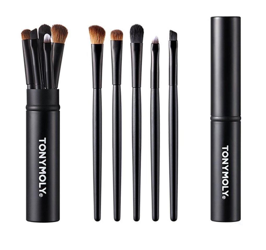Set of five sleek black makeup brushes with soft bristles displayed beside matching closed tube container