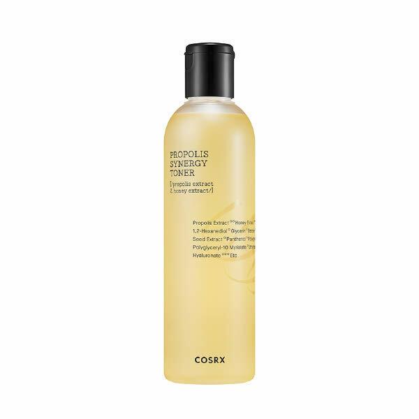 Tall translucent bottle with golden liquid propolis toner and black flip cap on white background